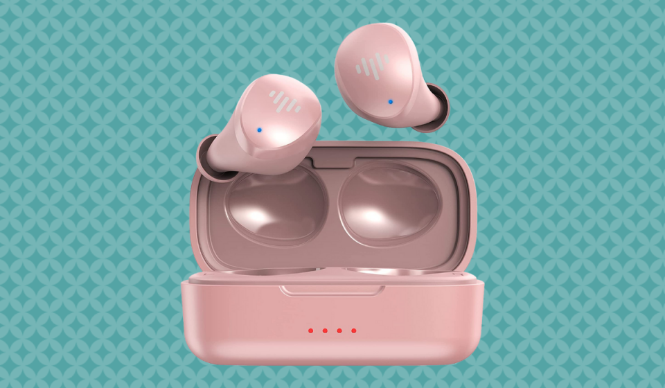 A pair of pastel pink wireless earbuds popping out of their pink charging case