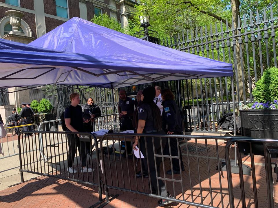 A Columbia University student scans his ID at a security checkpoint outside the gates on Amsterdam Avenue in New York City on May 1, 2024. (Katie Mather/Yahoo News)