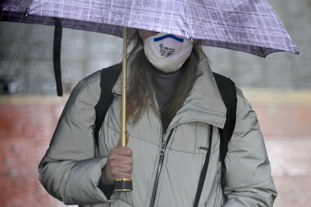 A person wearing a face mask as a preventive measure against the COVID-19 disease walks in Vilanova i la Geltru on March 30, 2020. - Spain confirmed another 812 deaths in 24 hours from the coronavirus today, a slight decline on the previous day's toll, bringing the total number of deaths to 7,340. The country, which has the world's second most deadly outbreak after Italy, recorded 838 deaths from the pandemic yesterday, its third straight daily record for coronavirus deaths. (Photo by LLUIS GENE / AFP) (Photo by LLUIS GENE/AFP via Getty Images)