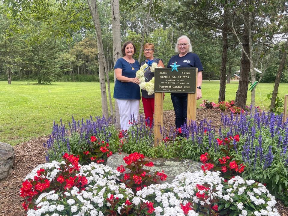 Standing behind the Blue Star Memorial By-Way Marker at Patriot Park are, left to right: Leeanna Ryba, president of the Garden Club Federation of Pennsylvania, and Somerset Garden Club members Linda Musser and Jan Szych.