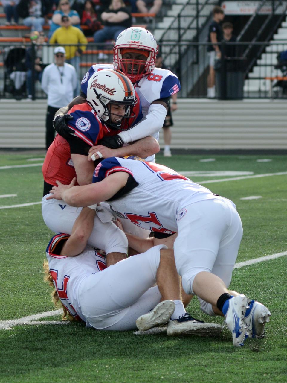 Ridgewood's Gabe Tingle, of the South team, is tackled by Cleveland Villa Angela-St. Joseph's Andre Terry, top, Clyde's Blue Norman and Navarre Fairless' Colton Colucci during the fourth quarter of a 13-0 win during the annual Ohio North-South All-Star Football Classic on Saturday at Paul Brown Tiger Stadium in Massillon. Tingle, a quarterback, was playing football for the first time since breaking his ankle in a playoff game against Wheelersburg as a senior.