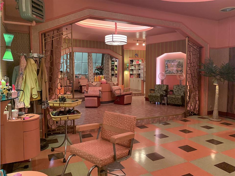 “We wanted to make the salon feel feminine,” says production designer Nelson Coates of the Art Deco meets ’60s–style set. “Andy [Baseman, set decorator,] found different fabrics that had seen a brighter color in their past, and we found a company who could print an old Formica patterns to place on the tabletops.”