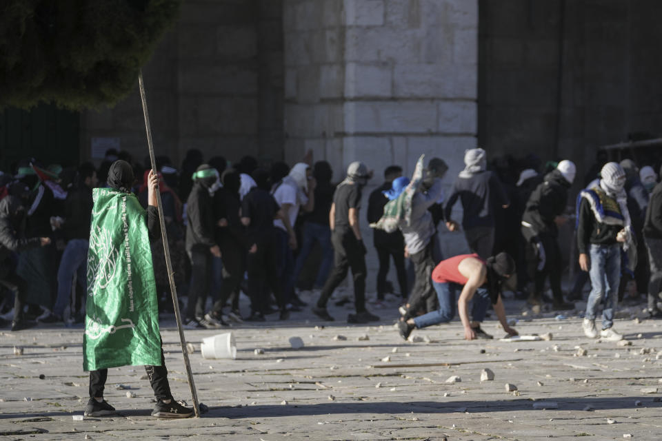 Palestinians clash with Israeli security forces at the Al Aqsa Mosque compound in Jerusalem's Old City Friday, April 15, 2022. (AP Photo/Mahmoud Illean)