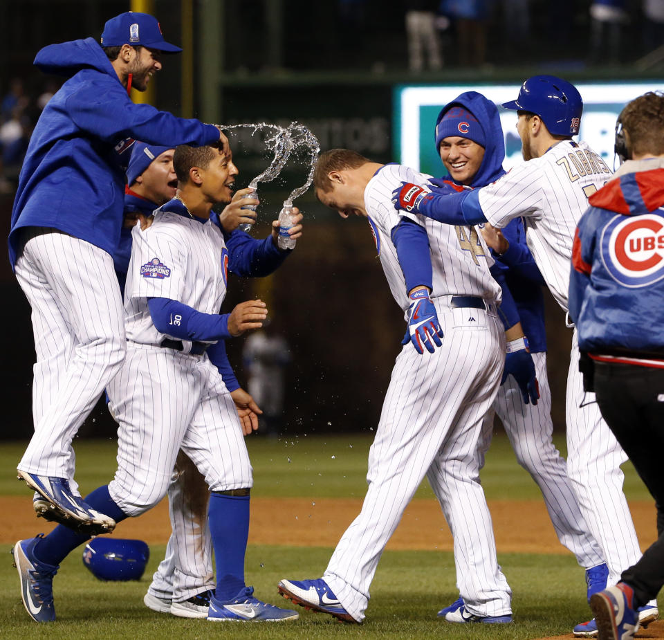 Chicago Cubs' Anthony Rizzo, center, celebrates with teammates after hitting the game-winning single against the Los Angeles Dodgers during the ninth inning of a baseball game Tuesday, April 11, 2017, in Chicago. The Cubs won 3-2. (AP Photo/Nam Y. Huh)