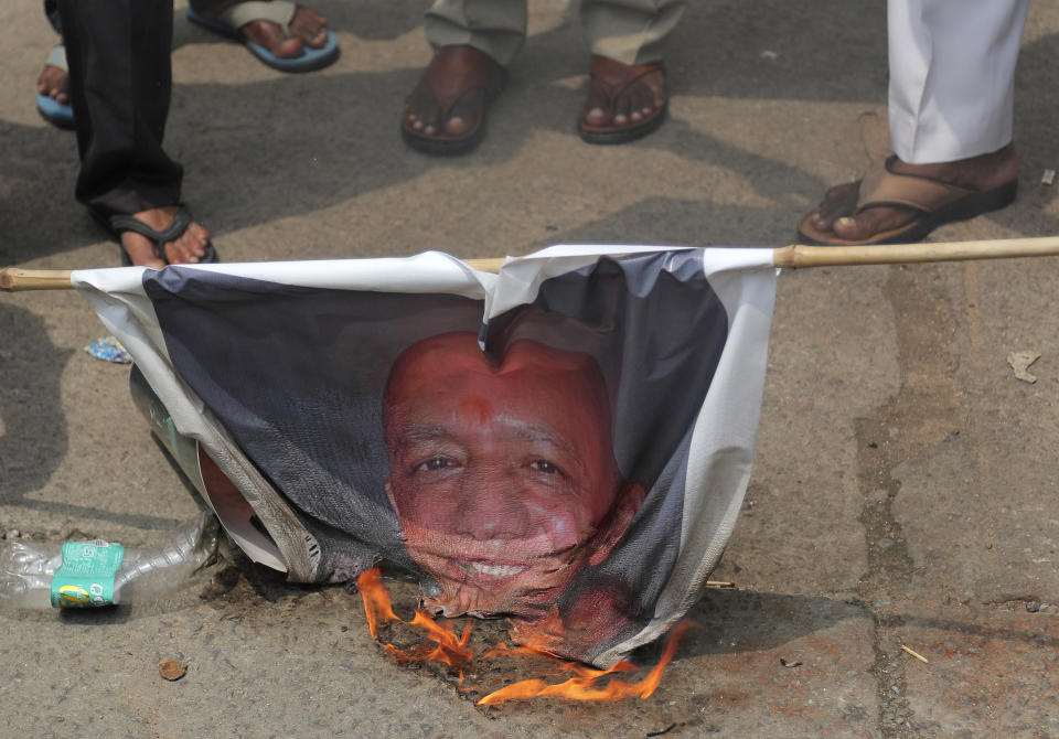 Activists burn a portrait of Uttar Pradesh state Chief Minister Yogi Adityanath during a protest against the gang rape and killing of a teenager, in Hyderabad, India, Thursday, Oct. 1, 2020. The gang rape and death of a woman from the lowest rung of India’s caste system sparked outrage across the country on Wednesday, with several politicians and activists demanding justice and protesters rallying in the streets. The attack of the 19-year-old is the latest gruesome case of sexual violence against women to rile India, where reports of rape are hauntingly familiar. (AP Photo/Mahesh Kumar A.)