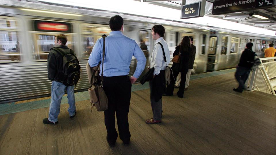 Commuters wait for a train on an elevated train platform Tuesday, April 5, 2005, in Chicago.