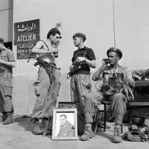 A file photo from November 1, 1956 shows Egyptian soldiers with a portrait of then president Gamal Abdel Nasser in Port Said at the height of the Suez canal crisis, after Nasser nationalised the key waterway