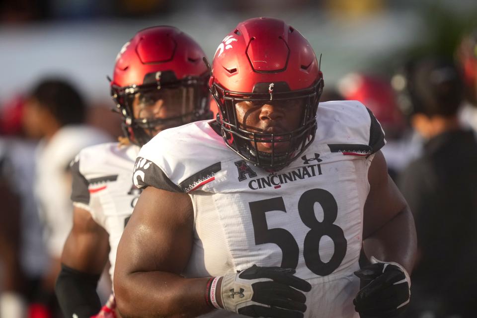 Bearcats defensive lineman Dontay Corleone (58) jogs off the field after recovering a fumble in the third quarter during their game against the UCF Knights Oct. 29.