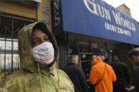 A gun store customer that gave his name only at John waits in line, Sunday, March 15, 2020, in Burbank, Calif. As consumers are buying all kinds of goods in large quantities amid coronavirus concerns, putting pressure on inventories, John stated that he was there to buy ammunition because most other stores were out and he wanted to stock up. (AP Photo/Mark J. Terrill)