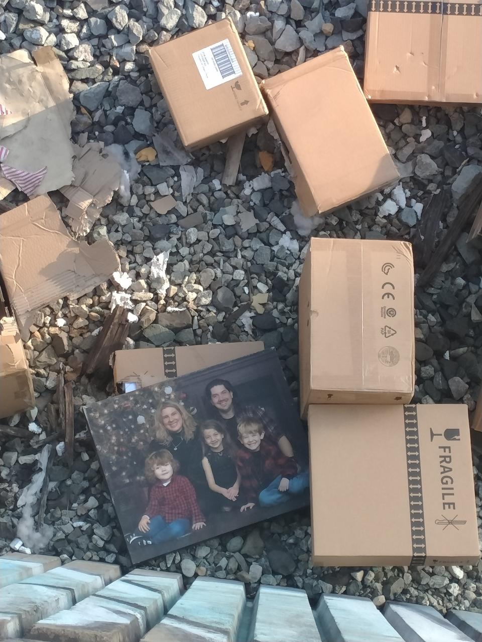 A family photo sits strewn among the debris alongside Los Angeles train tracks after thieves looted cargo containers, among dozens pried open and robbed in recent months.