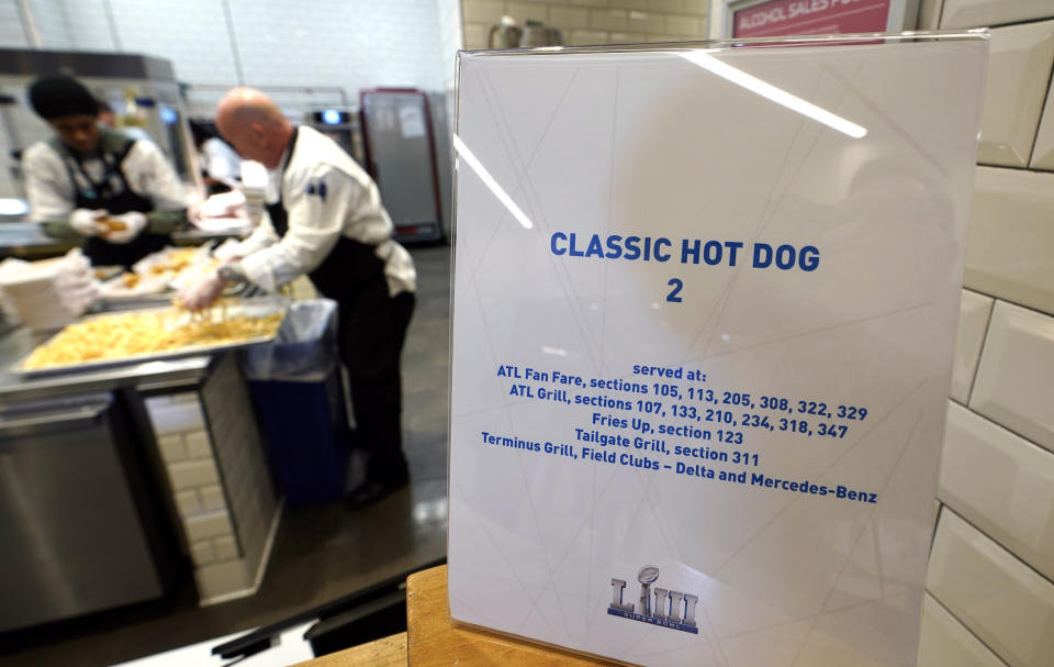 FILE - In this Jan. 29, 2019, file photo, workers prepare food for a media tasting event during a tour of Mercedes-Benz Stadium for the NFL Super Bowl 53 football game in Atlanta. (AP Photo/David J. Phillip, File)