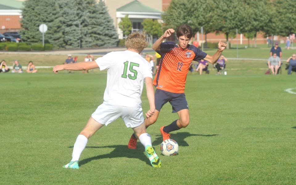 Galion's Max Albert dribbles around Clear Fork's Aaron Brown.