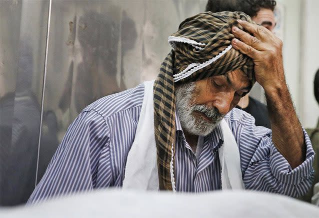 Palestinian Ahmed Jadallah, 75, takes a break as he prepares a body for burial at the morgue of Kamal Adwan hospital in Beit Lahiya, northern Gaza Strip, Thursday, July 24, 2014. Over the past three decades, the 75-year-old Jadallah has dressed hundreds of 'martyrs' _ those killed in conflict with Israel. He said his volunteer work fulfills an Islamic commandment and that he hopes it will earn him a place in paradise. Source: AP Photo