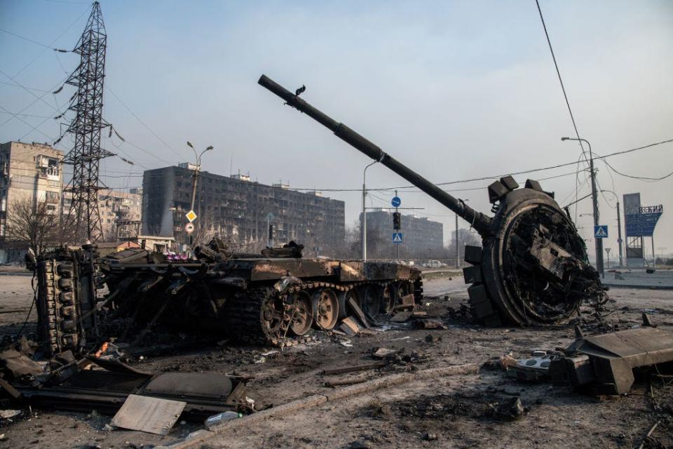 A destroyed tank likely belonging to Russia / pro-Russian forces lies amidst rubble in the north of the ruined city of Mariupol on March 23, 2022.