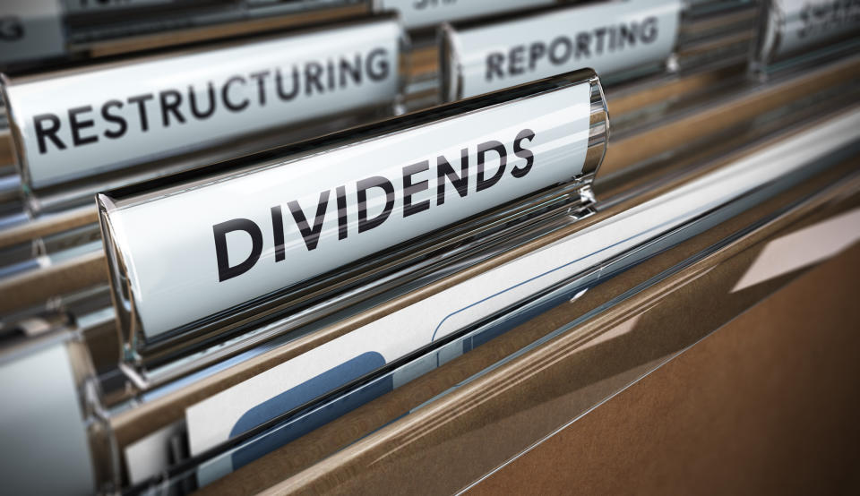 We see some file folders in a drawer, and the front one's tab is labeled dividends.