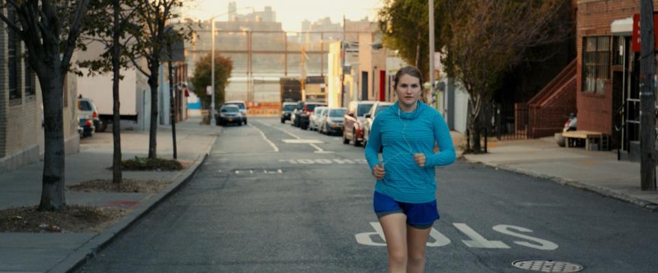 Jillian Bell runs down the street