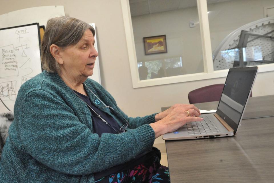 Grace Buscher of GMBSystems in Squantum pulls up websites on her laptop, checking to see if any are fake, created by scammers. She is presenting a series of digital workshops for seniors at the Milton Senior Center and also Quincy Elder Services. Friday, Feb. 16, 2024.