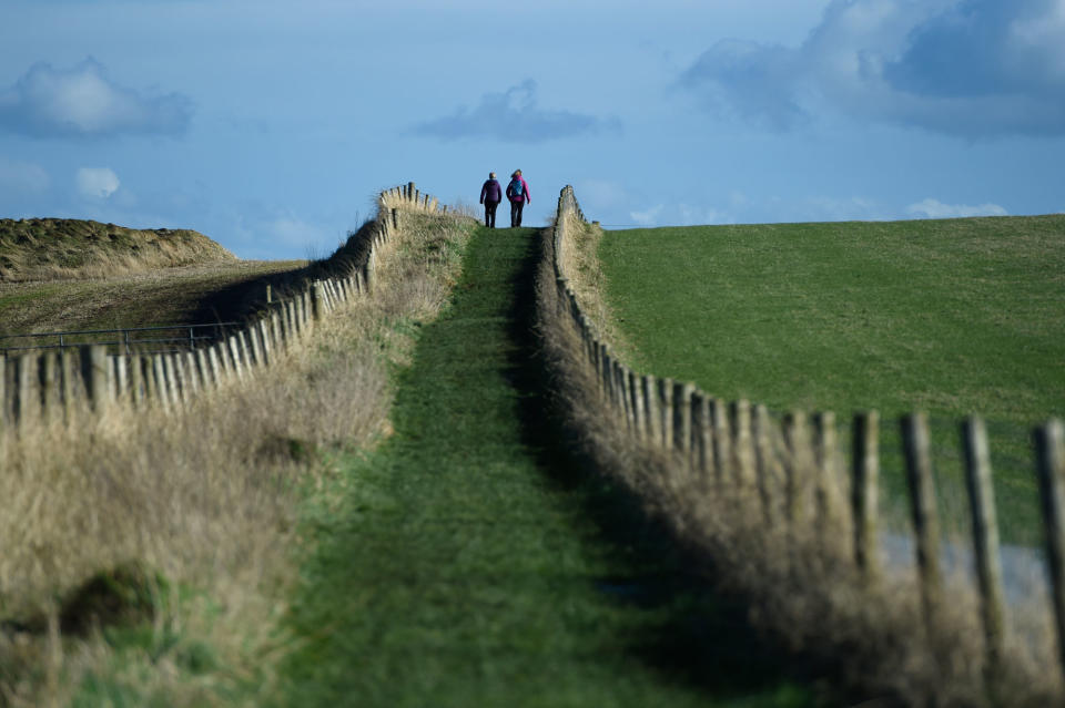 <p>People go for a walk along the Causeway Coastal route in Ballintoy, Northern Ireland February 27, 2017. (Clodagh Kilcoyne/Reuters) </p>