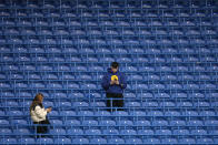 Spectators take their places in the stands ahead of the English Premier League soccer match between Chelsea and Liverpool at Stamford Bridge in London, Sunday, Jan. 2, 2022. (AP Photo/Matt Dunham)