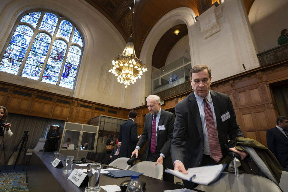 Richard C. Visek, acting legal adviser of the U.S. Department of state, right, arrives to address the United Nations' highest court during historic hearings in The Hague, Netherlands, Wednesday, Feb. 21, 2024, into the legality of Israel's 57-year occupation of the West Bank and east Jerusalem, plunging the 15 international judges back into the heart of the decades-long Israeli-Palestinian conflict. Six days of hearings at the International Court of Justice, during which an unprecedented number of countries will participate in proceedings, are scheduled as Israel continues its devastating assault on Gaza. (AP Photo/Peter Dejong)