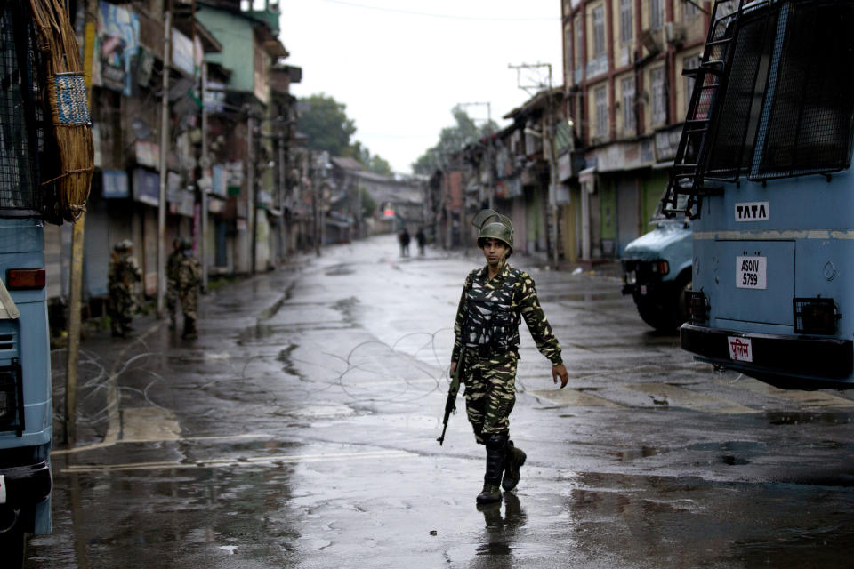 FILE - In this Wednesday, Aug. 14, 2019 file photo, an Indian paramilitary soldier patrols during security lockdown in Srinagar, Indian controlled Kashmir. Gulf Arab countries have remained mostly silent as India’s government moved to strip the Indian-administered sector of Kashmir of its limited autonomy, imposing a sweeping military curfew in the disputed Muslim-majority region and cutting off residents from all communication and the internet. (AP Photo/ Dar Yasin, File)