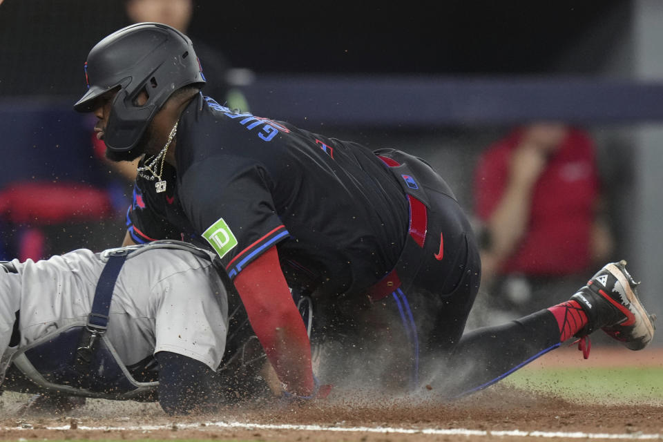 Toronto Blue Jays' Vladimir Guerrero Jr. is tagged out at home by New York Yankees catcher Jose Trevino during the fifth inning of a baseball game Friday, June 28, 2024, in Toronto. (Chris Young/The Canadian Press via AP)