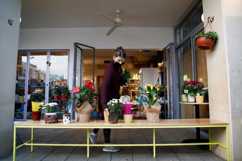 An employee sorts pot plants at a cafe as Israel further eases the coronavirus disease (COVID-19) restrictions in Tel Aviv