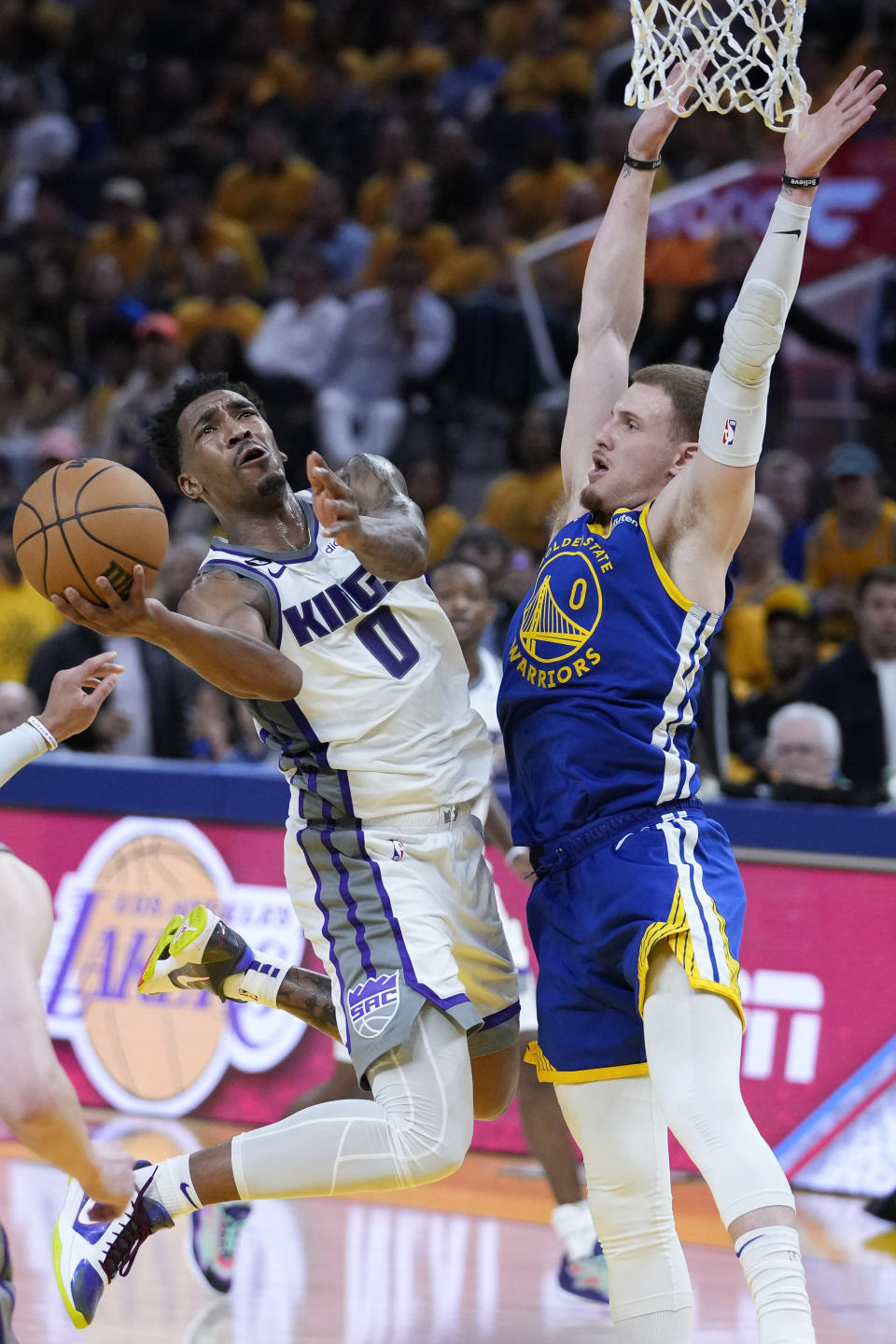 Sacramento Kings guard Malik Monk, left, shoots next to Golden State Warriors guard Donte DiVincenzo, right, during the first half of Game 6 of a first-round NBA basketball playoff series in San Francisco, Friday, April 28, 2023. (AP Photo/Godofredo A. Vásquez)
