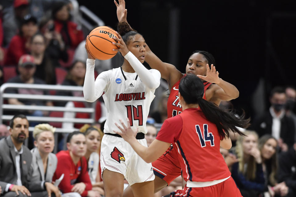 Louisville guard Kianna Smith (14) looks for help from pressure by Gonzaga guard Kaylynne Truong (14) and forward Yvonne Ejim (15) during the first half of a women's NCAA tournament college basketball second-round game in Louisville, Ky., Sunday, March 20, 2022. (AP Photo/Timothy D. Easley)