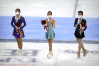 From left, women's singles silver medalist Kaori Sakamoto of Japan, gold medalist Mai Mihara of Japan, and bronze medalist Joanna So of Hong Kong pose on the ice during their medal ceremony at the Asian Open Figure Skating Trophy, a test event for the 2022 Winter Olympics, at the Capital Indoor Stadium in Beijing, Friday, Oct. 15, 2021. (AP Photo/Mark Schiefelbein)