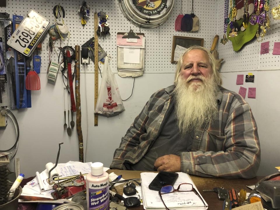 Danny Rice, 67, discusses the coronavirus in his auto repair shop in downtown Elmwood, Nebraska, on Monday, Nov. 9, 2020. Rice has continued his life as normal during the pandemic, even though he recognizes that the virus is potentially dangerous for high-risk people, including him. (AP Photo/Grant Schulte)