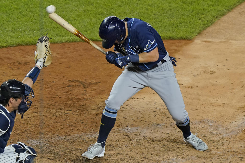 Tampa Bay Rays pinch-hitter Michael Brosseau ducks away from a pitch from New York Yankees reliever Aroldis Chapman during the ninth inning of a baseball game Tuesday, Sept. 1, 2020, at Yankee Stadium in New York, as catcher Kyle Higashioga reaches for the ball. (AP Photo/Kathy Willens)