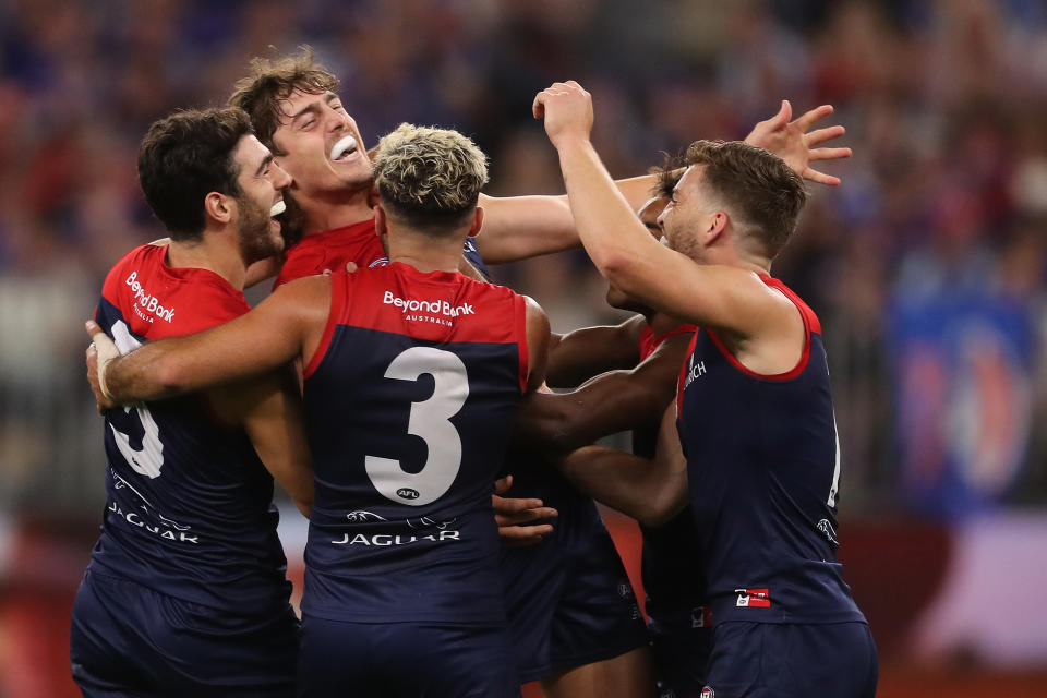 Pictured here, Melbourne Demons players celebrate their massive AFL grand final victory.