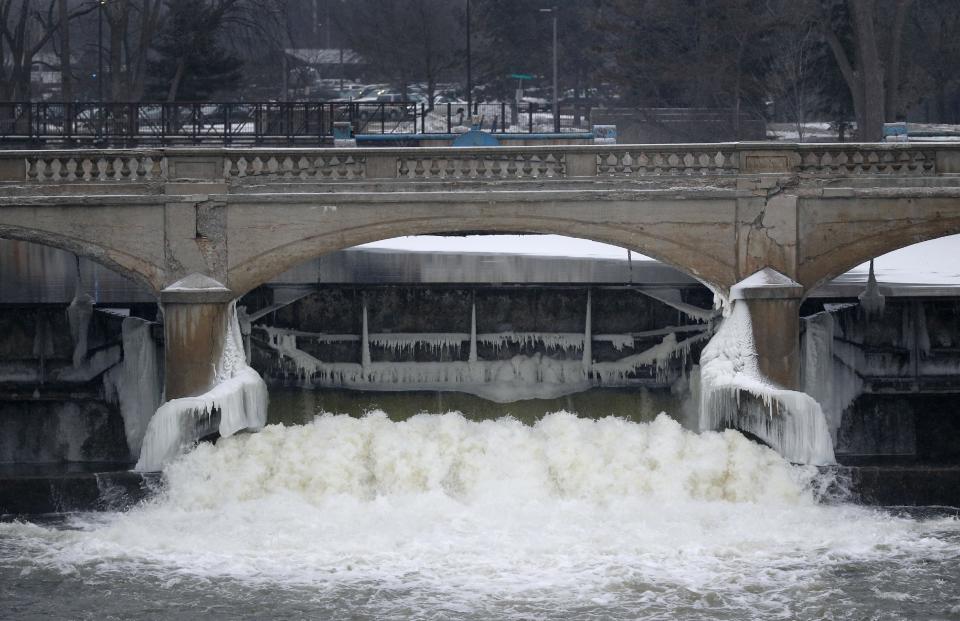 CLICK IMAGE FOR SLIDESHOW: Water from the Flint River flows through the Hamilton Dam near downtown Flint, Mich., on Jan. 21, 2016. As a part of efforts to get the city's finances in line, its water source was changed in April 2014, from a supply treated in Detroit and piped to Flint, to Flint River water treated and disseminated locally. It wasn&#39;t long before residents began complaining of yellow and brown water from their taps, along with an unpleasant taste and smell. People began seeing rashes on their skin and clumps of hair falling from their heads. Workers at a remaining GM plant found their parts were corroding. (AP Photo/Paul Sancya, File)