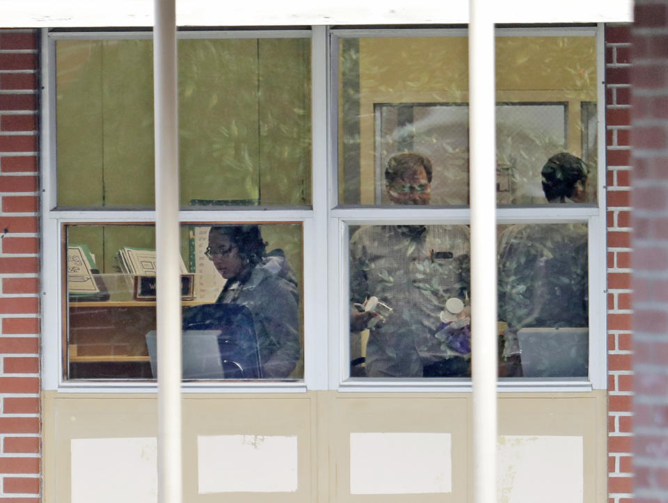 In this Jan. 4, 2019, photo, a toxicology team gathers samples inside the Sky Valley Education Center school in Monroe, Wash. The samples were tested for PCBs, or polychlorinated biphenyls, as well as dioxins and furans. A lawsuit filed on behalf of several families and teachers claims that officials failed to adequately respond to PCBs, or polychlorinated biphenyls, in the school. (AP Photo/Ted S. Warren)