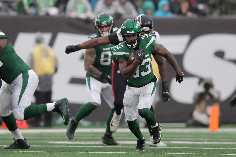 Dec 3, 2023; East Rutherford, New Jersey, USA; New York Jets running back Dalvin Cook (33) runs with the ball against the Atlanta Falcons during the first quarter at MetLife Stadium. Mandatory Credit: Brad Penner-USA TODAY Sports