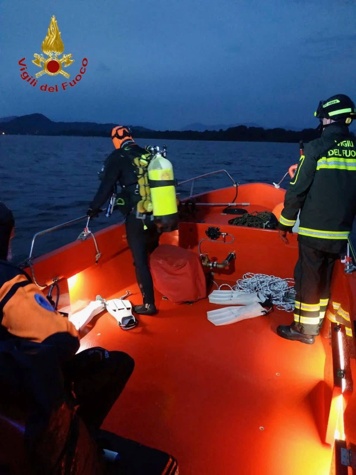 Firefighters search for survivors after the tourist boat capsized in Lake Maggiore (via REUTERS)
