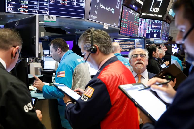 Traders work on the floor at the NYSE in New York