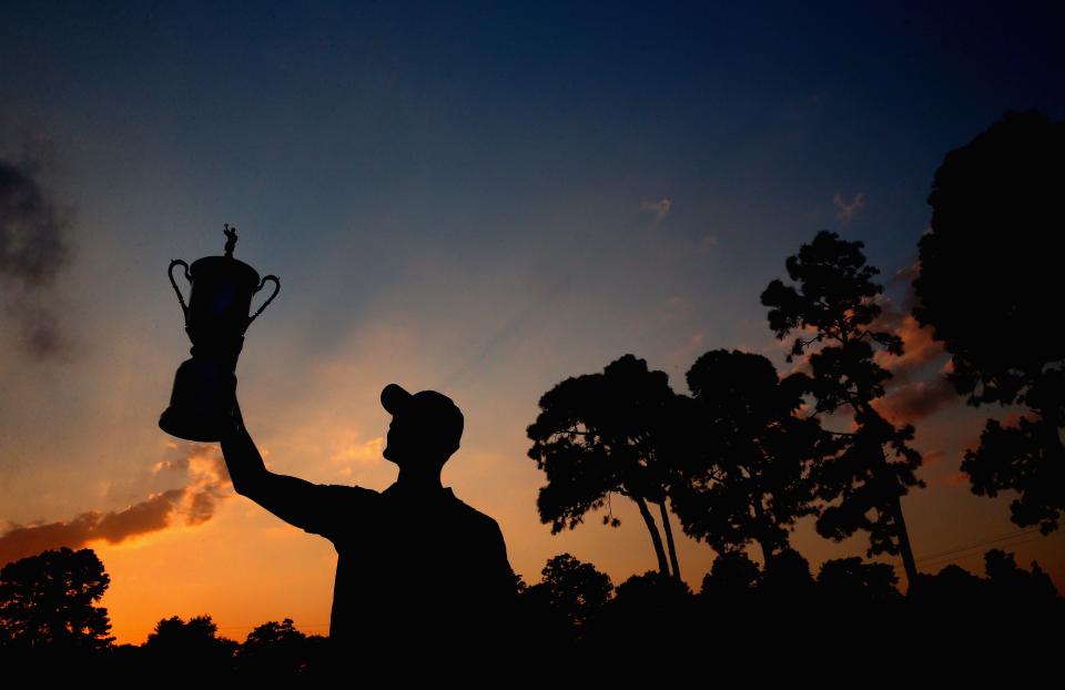 Martin Kaymer of Germany celebrates with the trophy after his eight-stroke victory during the final round of the 114th U.S. Open at Pinehurst Resort & Country Club, Course No. 2.