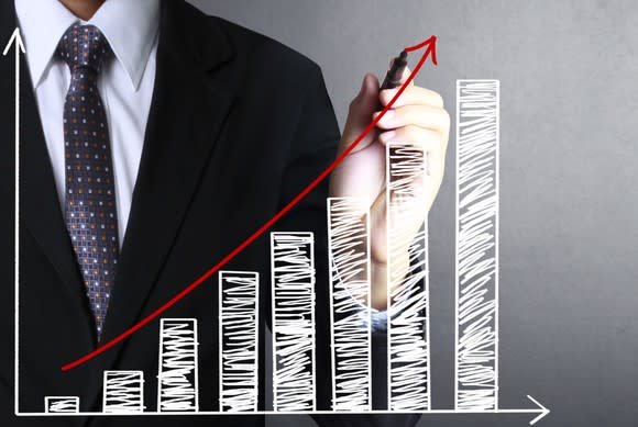 Businessman drawing a graph of gains