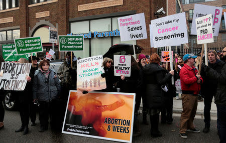 Anti-abortion activists (L) rally next to supporters of Planned Parenthood outside a Planned Parenthood clinic in Detroit, Michigan, U.S. February 11, 2017. REUTERS/Rebecca Cook