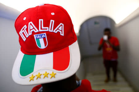 An adolescent migrant poses for a picture at an immigration centre in the Sicilian town of Caltagirone, Italy April 20, 2016. REUTERS/Tony Gentile