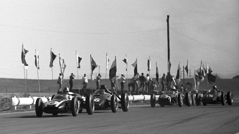 A black and white photo of F1 cars at the Riverside International Raceway. 