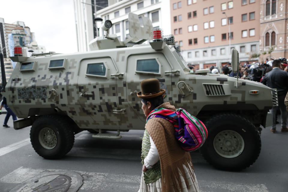 A military armored vehicle patrols as supporters of former President Evo Morales march from El Alto and enter La Paz, Bolivia, Tuesday, Nov. 12, 2019. Former President Evo Morales, who transformed Bolivia as its first indigenous president, flew to exile in Mexico on Tuesday after weeks of violent protests, leaving behind a confused power vacuum in the Andean nation. (AP Photo/Natacha Pisarenko)