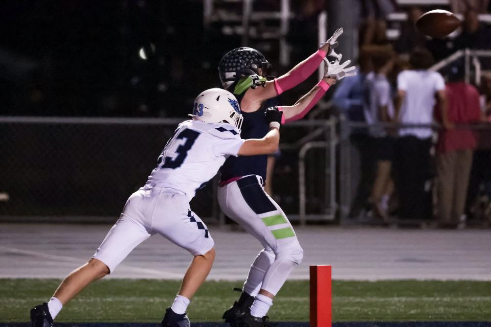 Timpanogos’ Luke Livingston makes an end zone catch in front of Salem Hills’ Nikolas Larsen, putting his team up 28-0 after the PAT, in a high school football game in Orem on Friday, Oct. 6, 2023. | Spenser Heaps, Deseret News