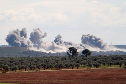 Smoke billowed over the village of Qaminas, southeast of Idlib, following reported Russian air strikes