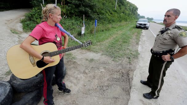 PHOTO: In this Aug. 30, 2016, file photo, activist Jessica Reznicek talks with Lee County Sheriff's Deputy Steve Sproul while conducting a personal occupation and protesting the Bakken pipeline, at a pipeline construction site, near Keokuk, Iowa. (John Lovretta/The Hawk Eye via AP, FILE)