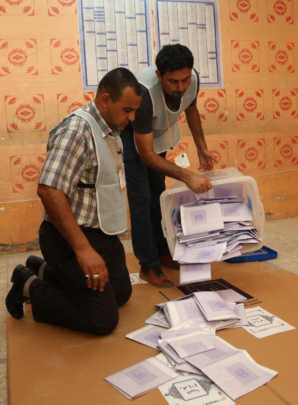 Electoral workers count ballots as polls close at a polling center in Basra, Iraq's second-largest city, 340 miles (550 kilometers) southeast of Baghdad, Iraq, Wednesday, April 30, 2014. Iraqis braved the threat of bombs and other violence to vote Wednesday in parliamentary elections amid a massive security operation as the country slides deeper into sectarian strife. (AP Photo/ Nabil al-Jurani)