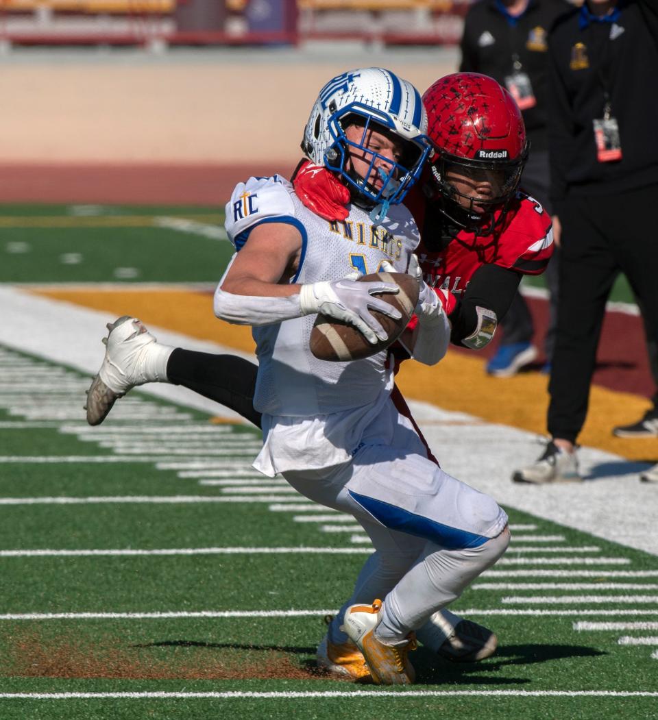 Ripon Christian's Brady Grondz, right, is tackled by Woodland Christian's Noah Hinkle during the Sac-Joaquin Section Division VII football championship at Hughes Stadium in Sacramento on Nov. 25, 2023. Woodland Christian won 36-14.