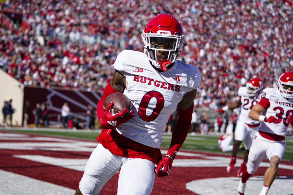 Rutgers defensive back Eric Rogers (0) runs in for a touchdown on a blocked punt against Indiana during the first half of an NCAA college football game in Bloomington, Ind., Saturday, Oct. 21, 2023. (AP Photo/Michael Conroy)